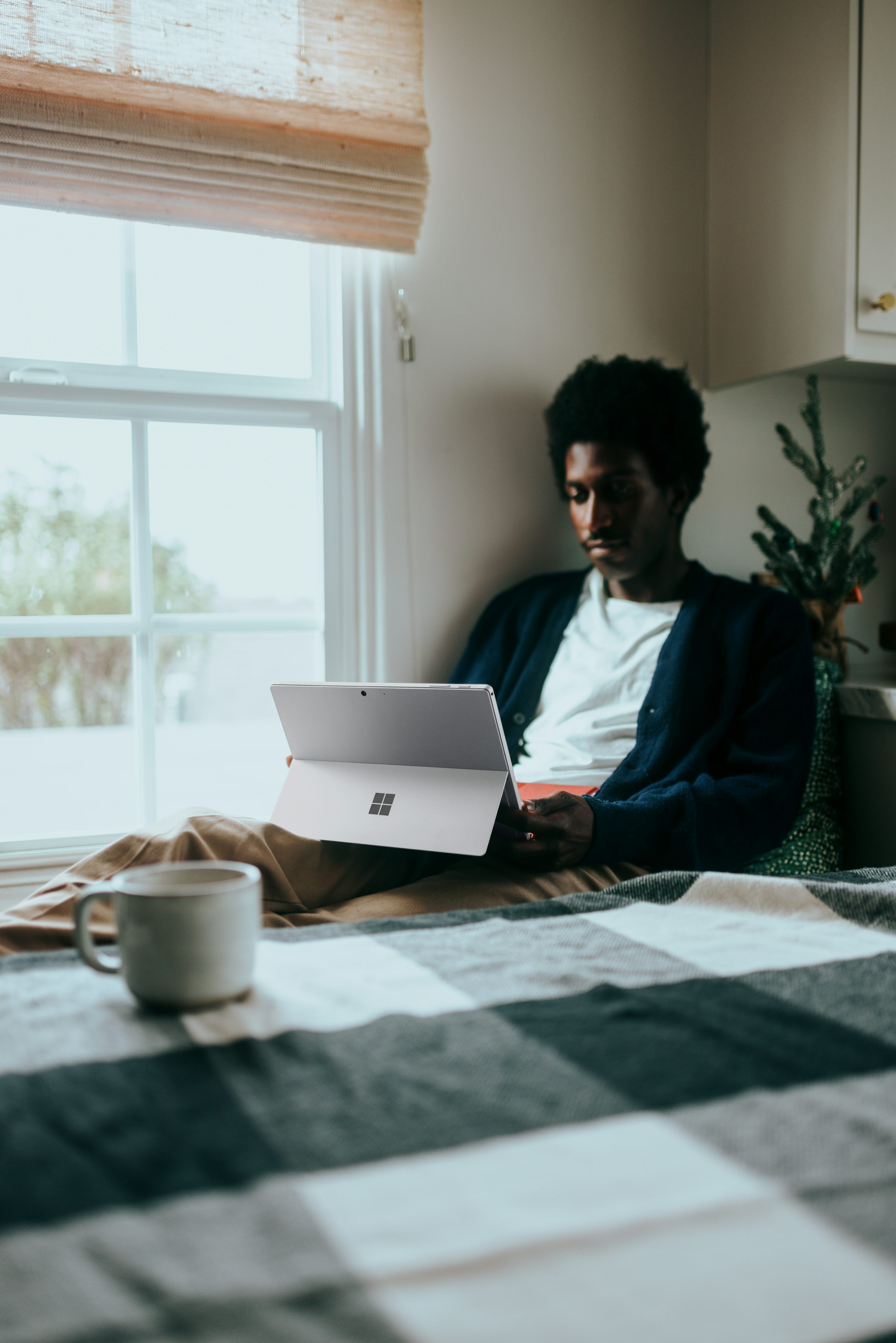 Person sitting by window working on tablet